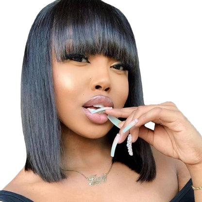 A woman wearing a short human hair bob wig with straight-cut bangs, in a sleek straight style.