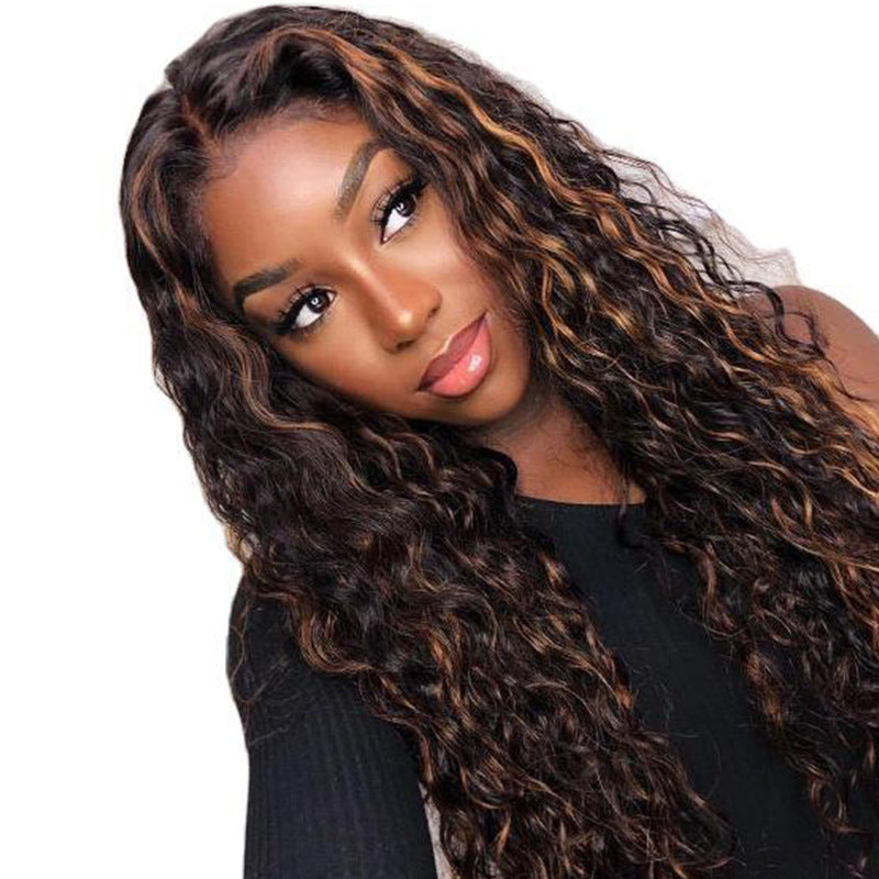 A woman wearing a long curly lace front wig with the brand name 'Prestigant' visible.